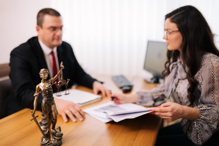 Male attorney sitting with female client